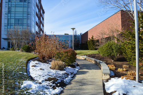 Beautiful snowy green meadow near office building, Waltham, USA photo