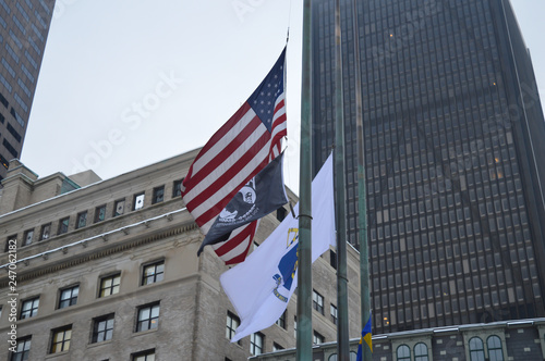 Americans flags at foggy building background storm in Boston, USA on December 11, 2016.