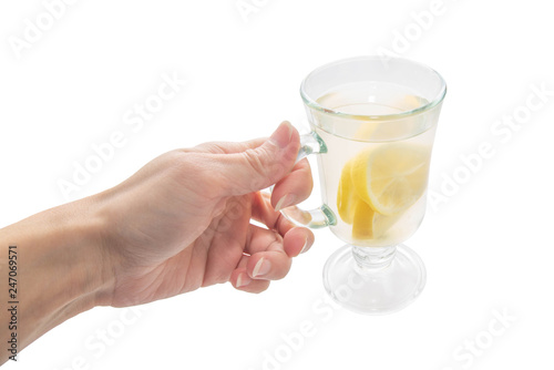 lemon tea with clear glass mug in female hand on white isolated background