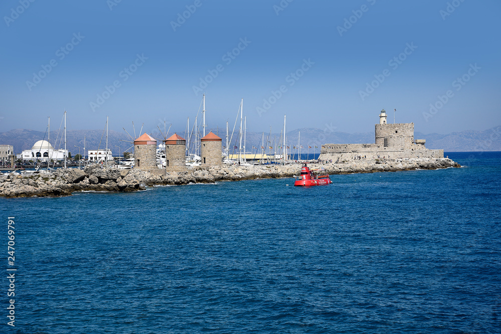 Cruise ships call into the deepwater harbour in Rhodes Greece. Mandraki is the ancient harbour with tour boats