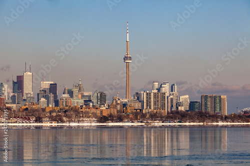 Toronto  CANADA - February 1th  2019  Panoramic Canadian winter landscape near Toronto  beautiful frozen Ontario lake at sunset. Scenery with winter trees  water and blue sky.