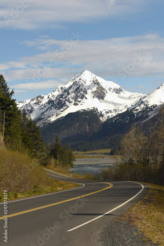 A winding road leading to a snow covered mountain in Alaska