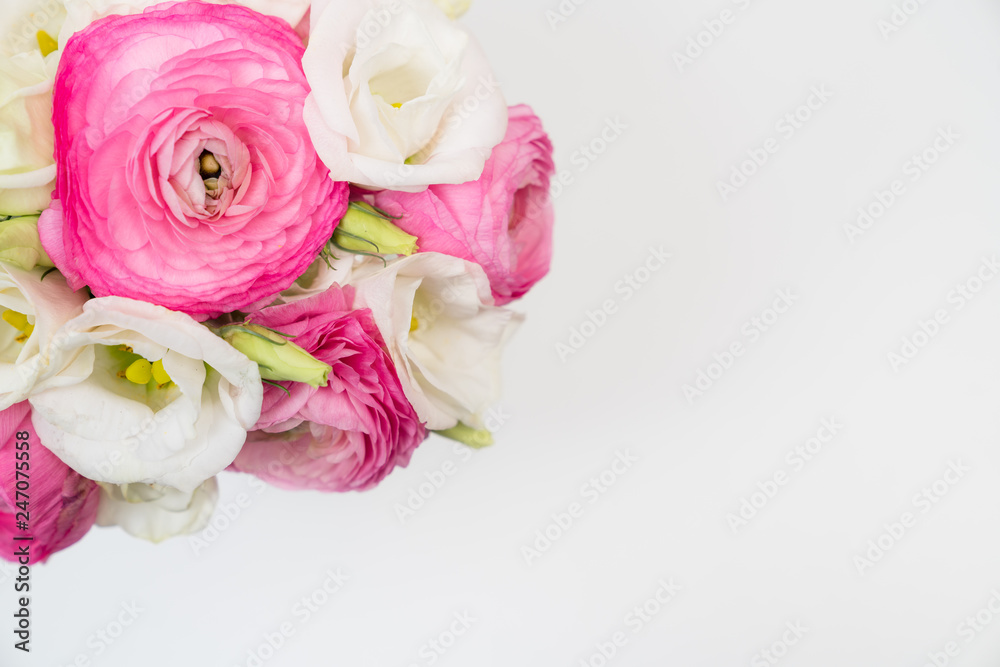 Ranunculus and lisiathus floral bouquet flat lay on white background