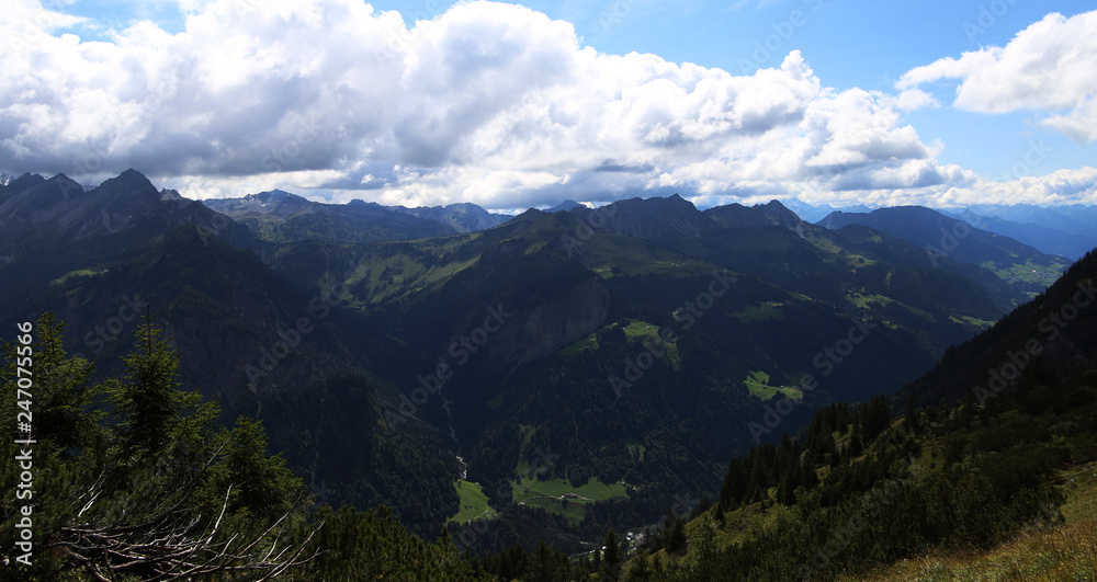 view of mountains with clouds and blue sky