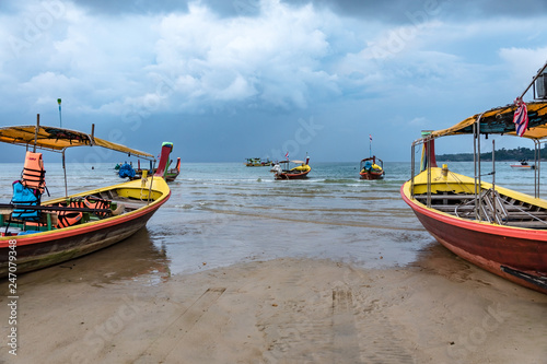 Colourful boats on the sand beach in Phuket, Thailand