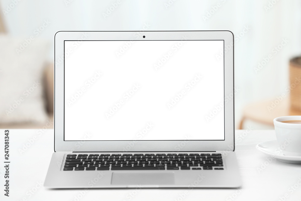 Fototapeta premium Laptop with blank screen on table indoors. Space for text