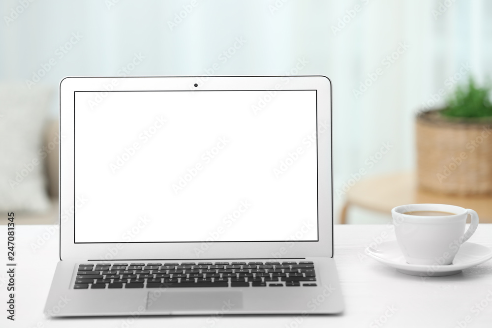 Fototapeta premium Laptop with blank screen on table indoors. Space for text