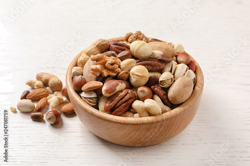 Bowl with organic mixed nuts on wooden table