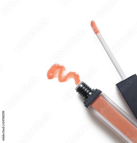 Beige liquid lipstick with smear and applicator isolated on white, top view. Space for text photo