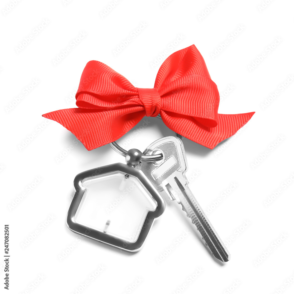 Obraz premium House key with trinket and bow on white background