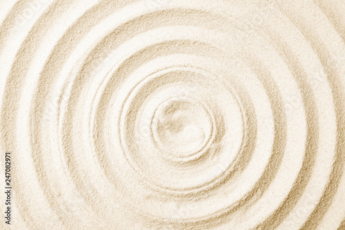 Zen garden pattern on sand as background, top view. Meditation and harmony