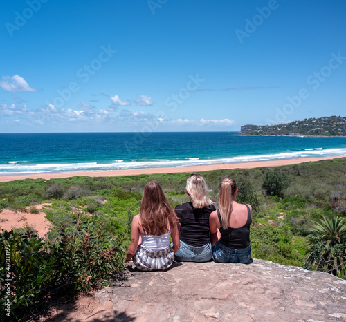 3 women looking out over beach
