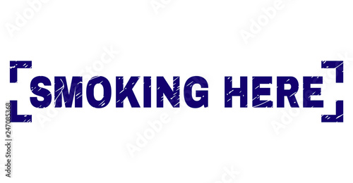 SMOKING HERE text seal print with corroded texture. Text caption is placed between corners. Blue vector rubber print of SMOKING HERE with retro texture.