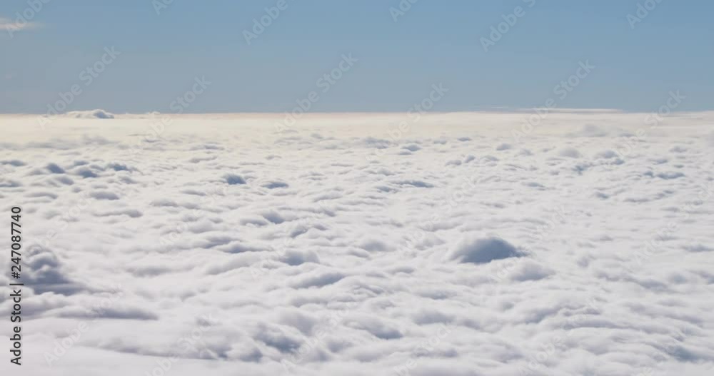 Magnificent fluffy white clouds and clear blue sky on bright sunny day. View from the airplane in motion. Magnificent fluffy white clouds and clear blue sky on bright sunny day. View from the airplane in motion.