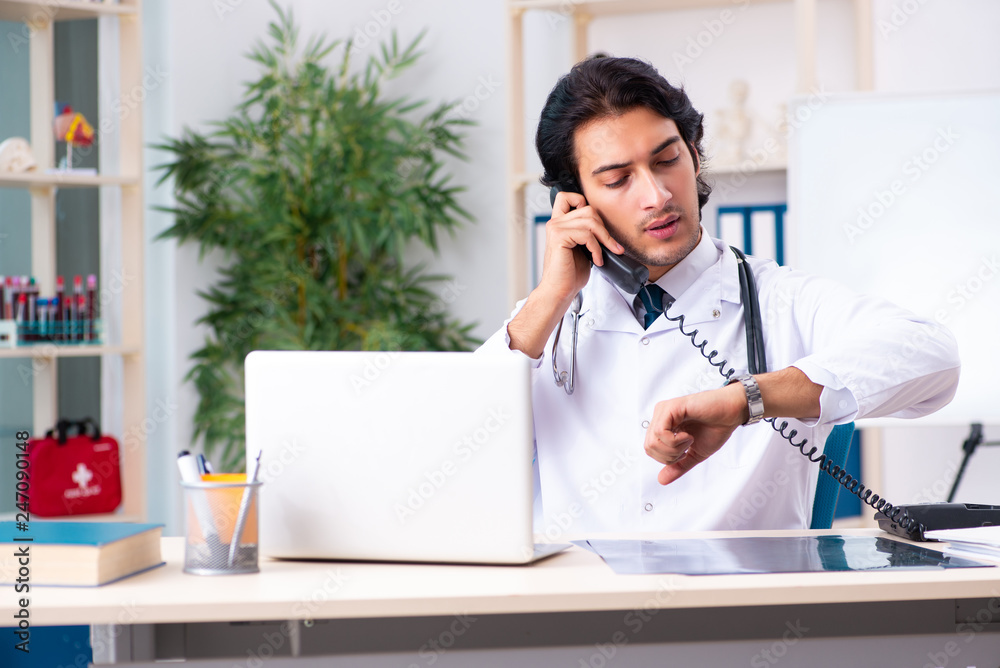 Young handsome doctor in telemedicine concept Young handsome doctor in telemedicine concept