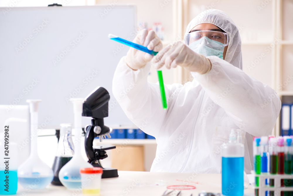 Young handsome chemist working in the lab Young handsome chemist working in the lab