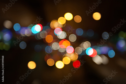 Night city street lights colorful bokeh background, darkness concept
