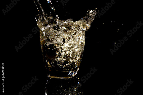 Glass of water on black background