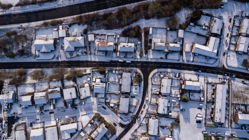 Top down aerial view of roads and houses covered in fresh snowfall (Ebbw Vale, Wales, UK)