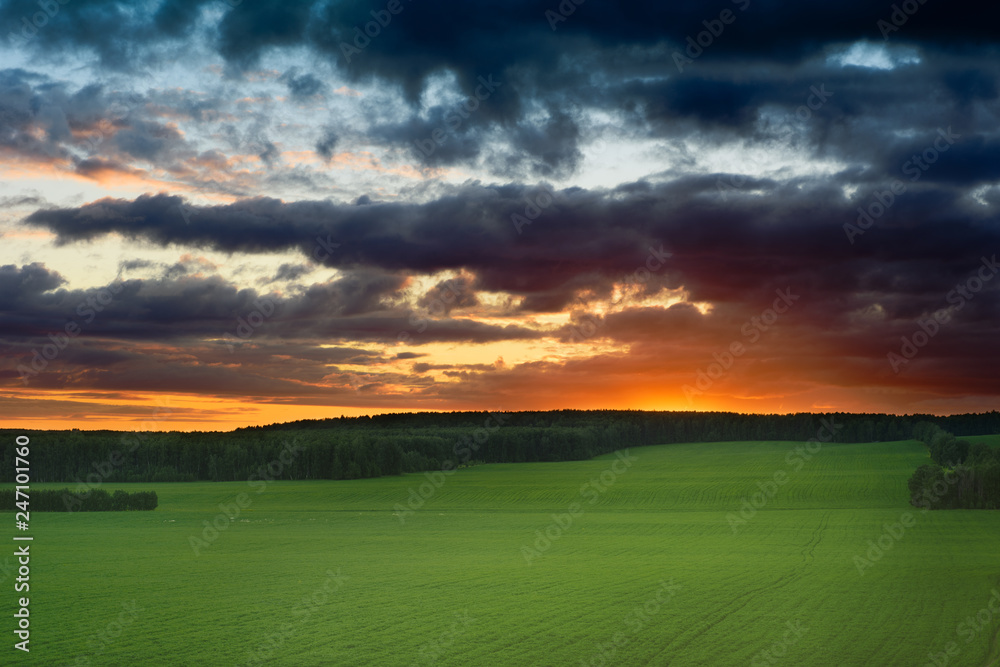 sunset and thunderstorm over the field