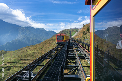 Tourist mountain tram, the transporation to Fansipan cable car station in Sapa town, Vietnam, with mountain landscape scene photo