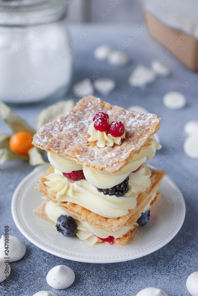 Tea and sweets on a light background, Mille-feuille, Eclairs, Tart, Decorative with flowers, Selective focus, Closeup Tea and sweets on a light background, Mille-feuille, Eclairs, Tart, Decorative with flowers, Selective focus, Closeup