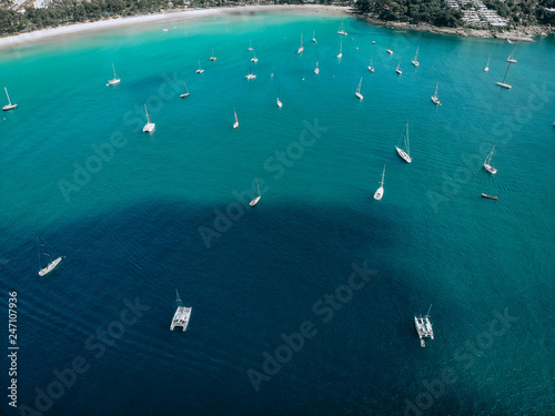 Aerial view of many anchoring yachts in open water. Ocean and sea travel and transportation.. © Semachkovsky 