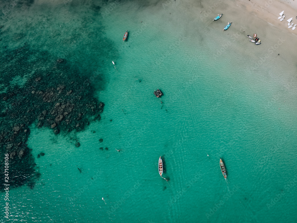 Blue sky.There are many Vietnamese Asian colored boats in the ocean near the isolated Island. the view from the top