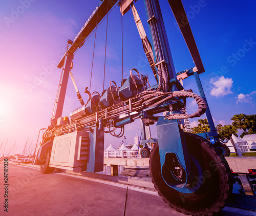 Lifting crane for elevating boat at harbor docks. photo