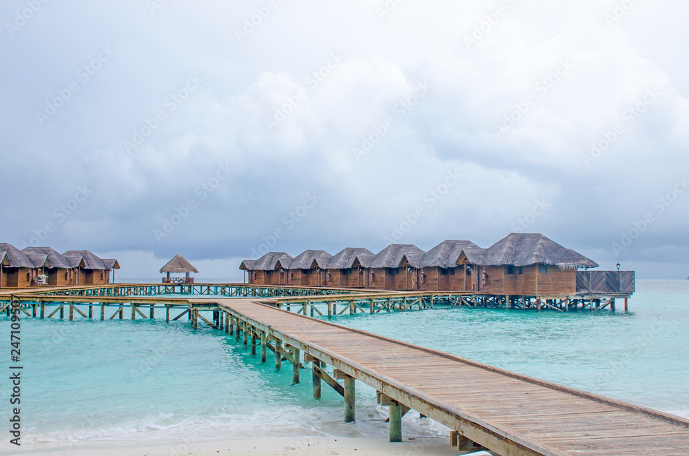 the island of Maldives of the house on Fiholhohi water a landscape the beach with blue water of the Indian Ocean in cloudy day