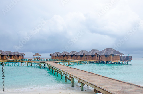 the island of Maldives of the house on Fiholhohi water a landscape the beach with blue water of the Indian Ocean in cloudy day © rosetata