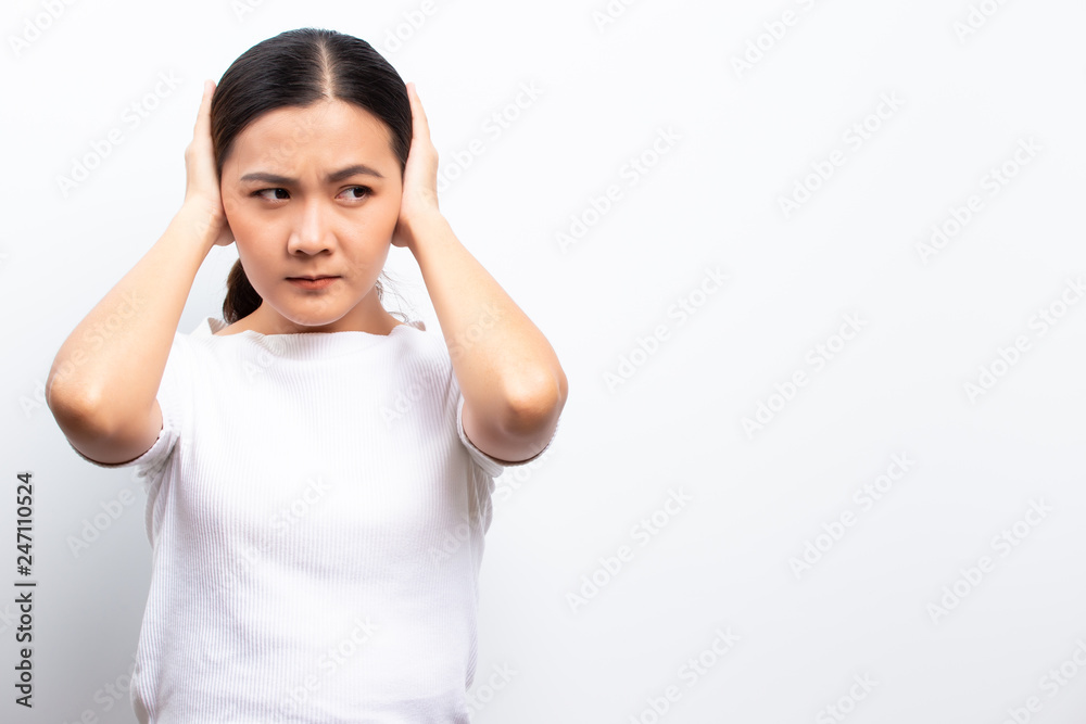 Sad woman covering her ears standing isolated over white background Sad woman covering her ears standing isolated over white background