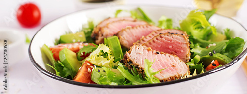 Tuna salad. Japanese traditional salad with pieces of medium-rare grilled Ahi tuna and sesame with fresh vegetable on a bowl. Authentic Japanese food. Banner