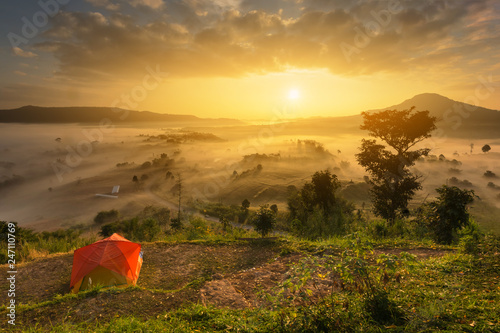 Orange tent accommodation of tourists to watch the mist black mountain with foggy sunrise. View from the scenic Khao Takian Ngo-Khao Kho-Phetchabun Thai land. photo