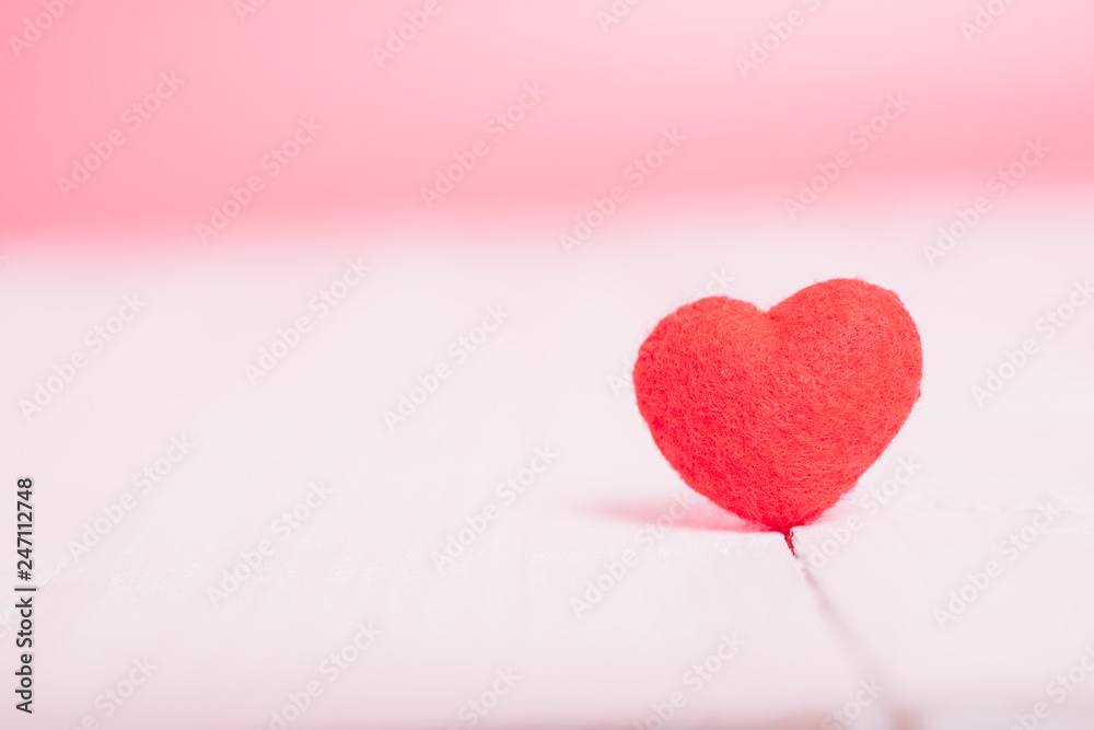 Red heart on white wooden have pink background