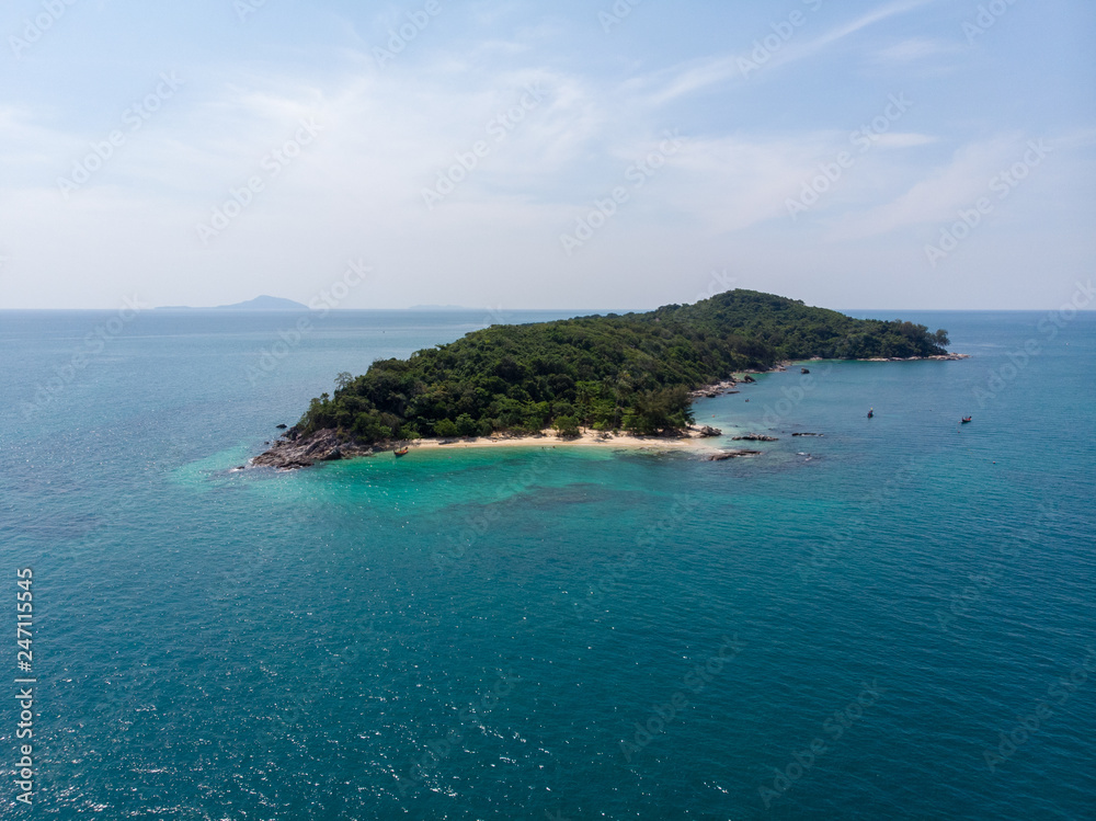 Isolated beautiful tropical island with white sand beach and blue clear water and granite stones. Top view, speedboats above coral reef. Similan Islands, Thailand