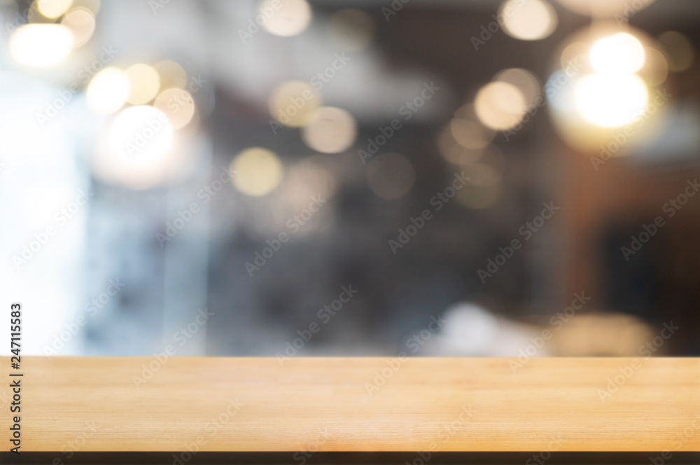 empty wood table with blur montage restaurant background.