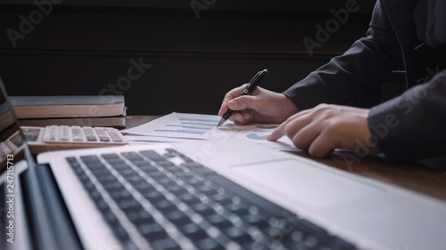 accountant calculating on data spreadsheets for research quality of company.