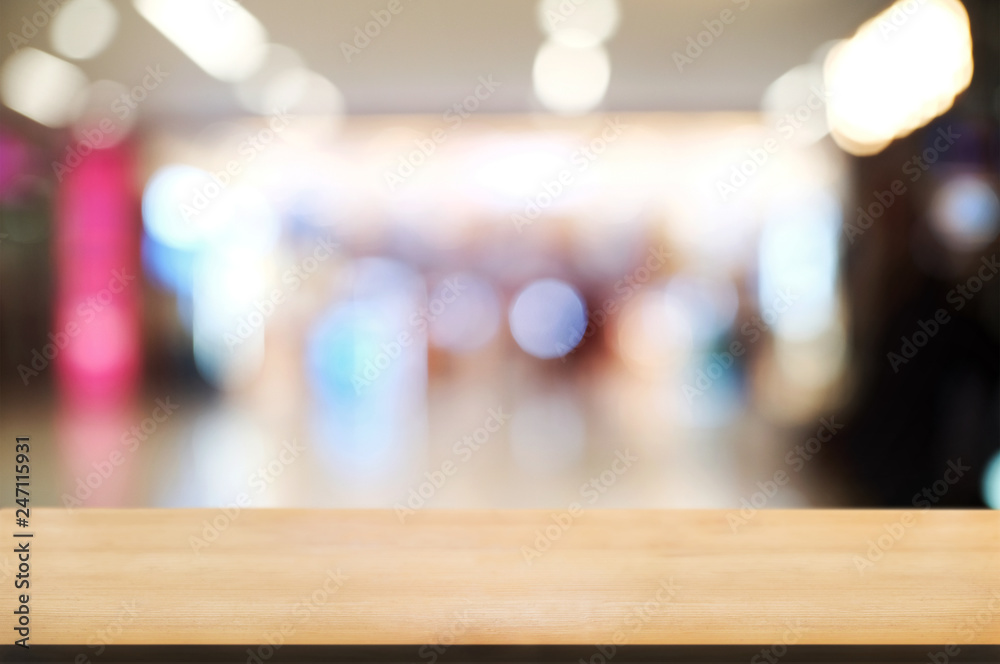 empty wooden tabletop over blur hypermarket background.