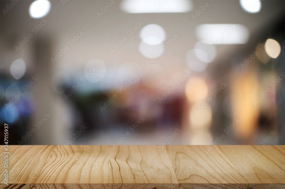 empty wooden tabletop over blur hypermarket background. empty wooden tabletop over blur hypermarket background.