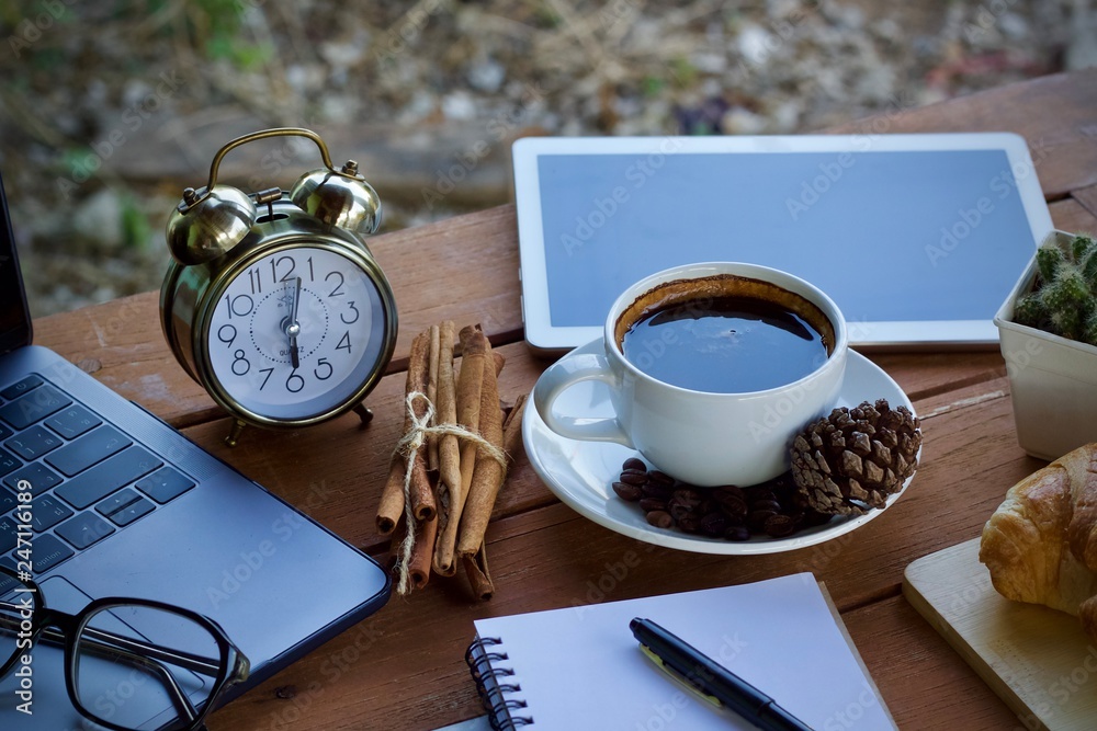 cup of coffee and notebook on a table cup of coffee and notebook on a table