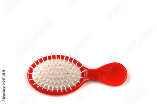 Elegant red hairbrush with handle isolated on white background.