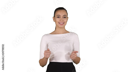Businesswoman walking and talking to the camera explaining or presenting on white background.