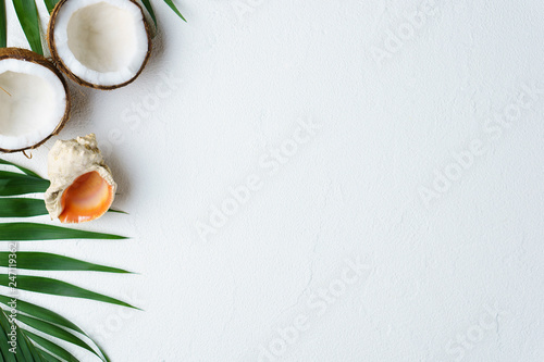 summer vacation, paradise, travel. ocean shore, tropical beach, sea coast. palm leaves and seashell on white background. minimal summertime concept. creative layout, banner or poster template