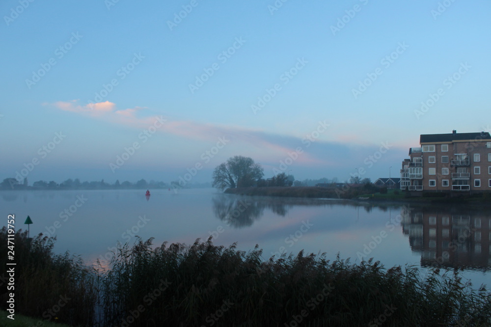 Fog during sunrise over the river Hollandsche IJssel in Moordrecht the Netherlands,