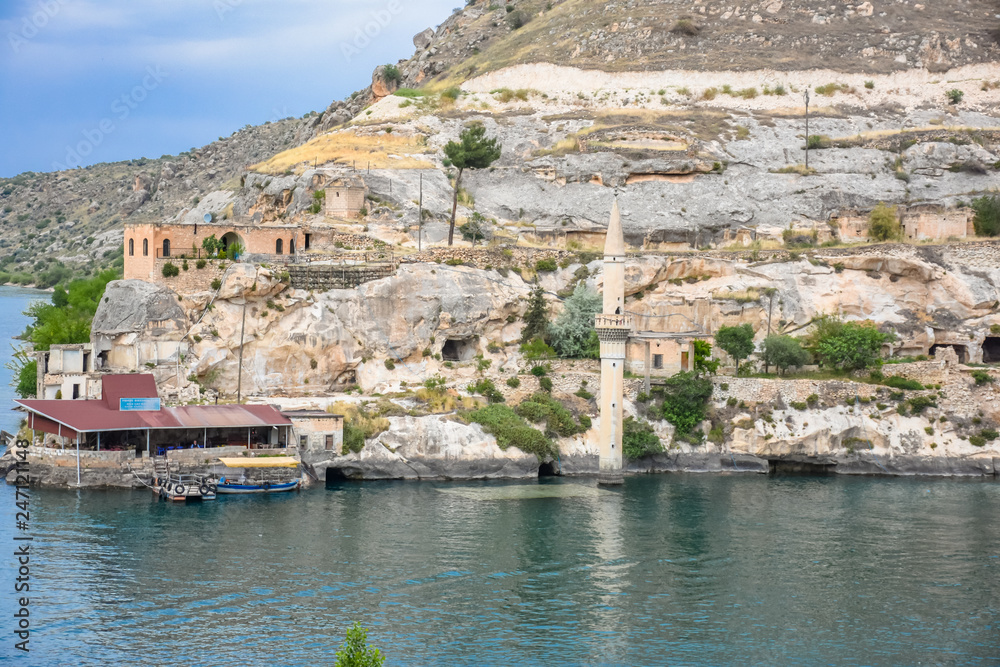 view of Sunken mosque and houses of the town Halfeti in Sanliurfa - Urfa, Turkey. The town and mosque has remained under the birecik dam water of a reservoir on the Euphrates.