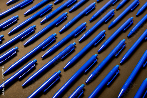 Blue pens on black background 