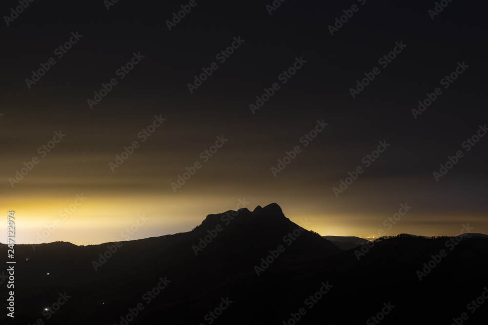 Night in the natural park of Aiako Harriak with the glow of the rays behind, Euskadi Night in the natural park of Aiako Harriak with the glow of the rays behind, Euskadi