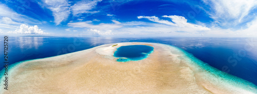 Aerial idyllic atoll, scenic travel destination Maldives Polinesia. Blue lagoon and turquoise coral reef. Shot in Wakatobi National Park, Indonesia photo