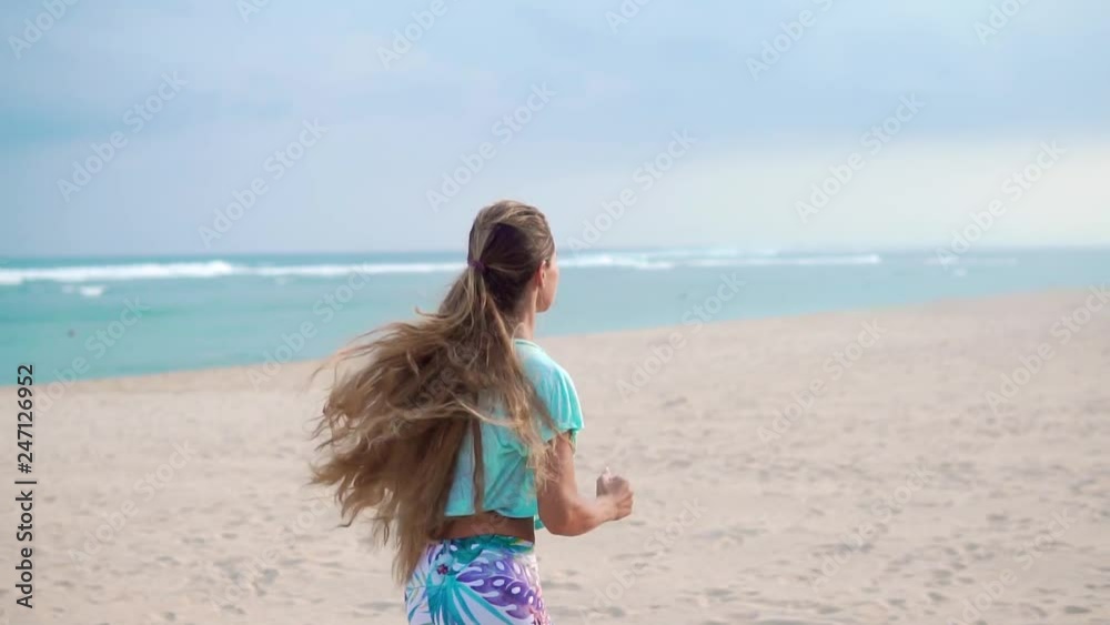 Woman running on beach at sunset. Beautiful fitness caucasian girl exercising outdoors on sea background. Caucasian fit model. Woman running on beach at sunset. Beautiful fitness caucasian girl exercising outdoors on sea background. Caucasian fit model.